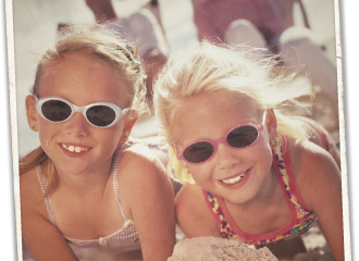 Young girls with sunglasses building sandcastles on Mexico Beach